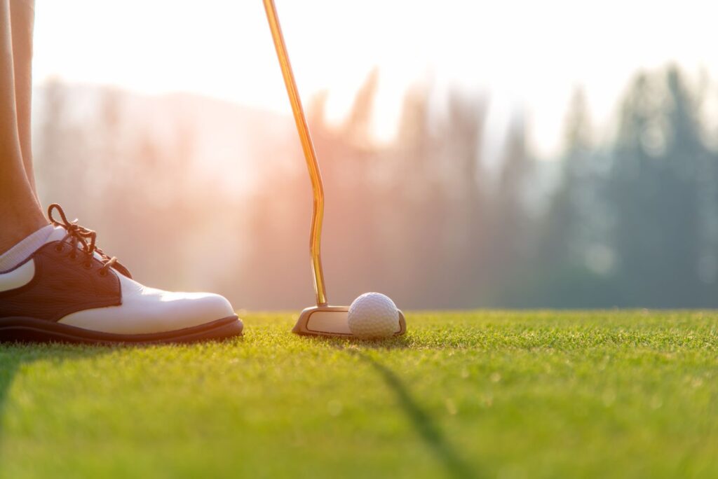 golfer getting ready to swing with putter