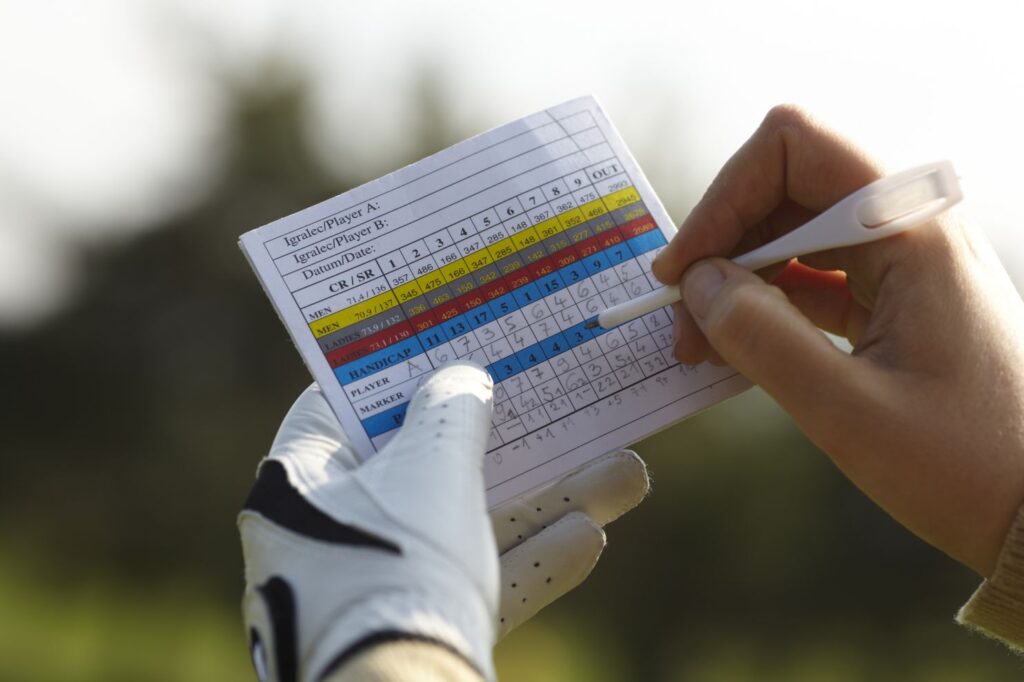 golfer keeping track of their score using score card