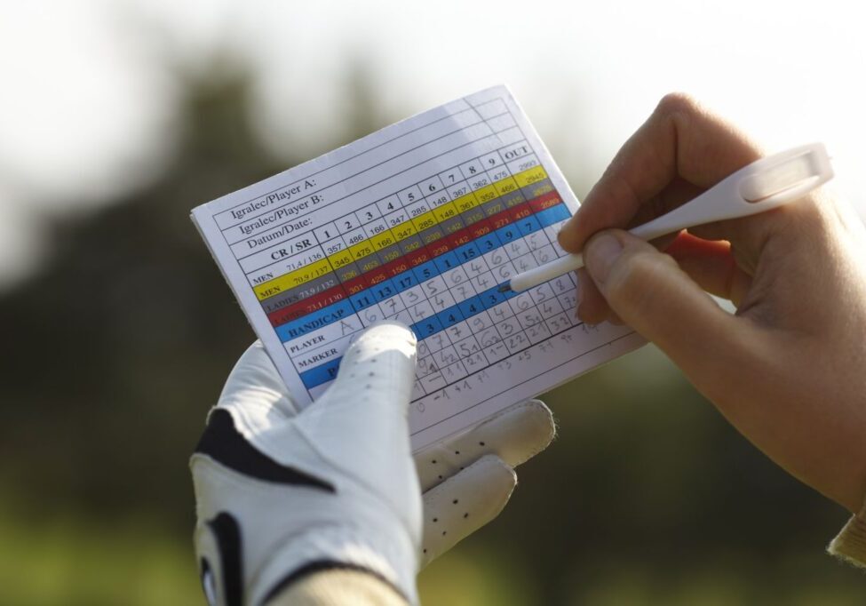 golfer keeping track of their score using score card
