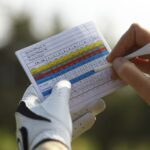 golfer keeping track of their score using score card